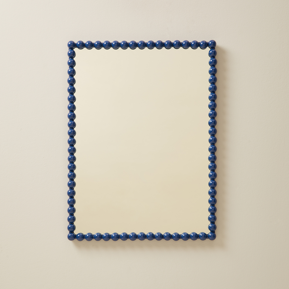 A stylish blue mirror on a plain background